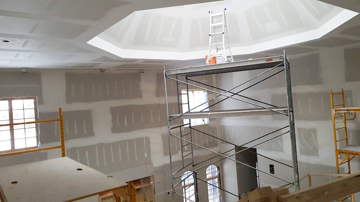 Drywall contractors in Mississauga installing tray ceiling with scaffolding